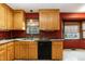 Kitchen features a double sink, black dishwasher, light wood cabinetry and two windows at 1508 Middle Ridge Dr, Willow Springs, NC 27592