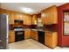 Spacious kitchen features stainless steel refrigerator, black oven and light wood cabinetry at 1508 Middle Ridge Dr, Willow Springs, NC 27592