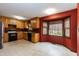 Kitchen features a double sink, black dishwasher, light wood cabinetry and two windows at 1508 Middle Ridge Dr, Willow Springs, NC 27592