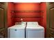 Laundry room features a white washing machine, dryer and wire shelving above at 1508 Middle Ridge Dr, Willow Springs, NC 27592