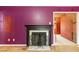 Close-up of a fireplace surrounded by purple walls in a home at 1508 Middle Ridge Dr, Willow Springs, NC 27592
