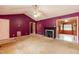 Spacious living room features a ceiling fan, fireplace and access to another room at 1508 Middle Ridge Dr, Willow Springs, NC 27592