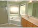 Bright bathroom featuring a garden tub, glass shower, and extended vanity at 1623 Rogers Pointe Ln, Creedmoor, NC 27522