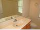 Bright bathroom vanity featuring a sink, cabinet, and large mirror at 1623 Rogers Pointe Ln, Creedmoor, NC 27522
