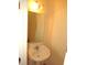 Cozy half bath with pedestal sink, decorative mirror, and classic lighting at 1623 Rogers Pointe Ln, Creedmoor, NC 27522