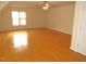 Bright bedroom featuring hardwood floors, neutral paint, and a ceiling fan, perfect for relaxing at 1623 Rogers Pointe Ln, Creedmoor, NC 27522