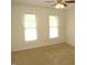 Bright bedroom with large windows, ceiling fan, and neutral carpeting at 1623 Rogers Pointe Ln, Creedmoor, NC 27522
