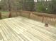 Wooden deck with a view of the surrounding woods, offering a peaceful retreat at 1623 Rogers Pointe Ln, Creedmoor, NC 27522