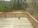 Outdoor wooden deck with railings and views of the surrounding woods at 1623 Rogers Pointe Ln, Creedmoor, NC 27522
