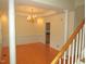 Elegant dining room with hardwood floors, classic wainscoting, and a beautiful chandelier at 1623 Rogers Pointe Ln, Creedmoor, NC 27522
