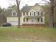 Charming two-story home with a classic design, complemented by a well-manicured front yard and attached garage at 1623 Rogers Pointe Ln, Creedmoor, NC 27522