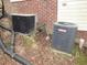 Close-up of two air conditioning units, showcasing the property's efficient climate control system at 1623 Rogers Pointe Ln, Creedmoor, NC 27522