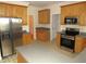 Well-equipped kitchen with stainless steel appliances, ample counter space, and classic wood cabinetry at 1623 Rogers Pointe Ln, Creedmoor, NC 27522