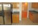 Functional kitchen showing stainless steel refrigerator and wood cabinetry in a cozy layout at 1623 Rogers Pointe Ln, Creedmoor, NC 27522