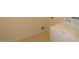 Close-up of a utility room with cream paint and a white washing machine at 1623 Rogers Pointe Ln, Creedmoor, NC 27522