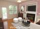 Staged living room showcases a fireplace, hardwood floors, and natural light at 1623 Rogers Pointe Ln, Creedmoor, NC 27522