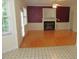 Cozy living room with a fireplace, hardwood floors, and large windows at 1623 Rogers Pointe Ln, Creedmoor, NC 27522