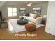 A modern living room with a comfortable sectional sofa, unique coffee table, and hardwood floors at 1623 Rogers Pointe Ln, Creedmoor, NC 27522