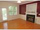 Living room with a fireplace, hardwood floors, and lots of natural light at 1623 Rogers Pointe Ln, Creedmoor, NC 27522
