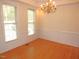 Empty living room showcasing hardwood flooring and natural light from the surrounding windows at 1623 Rogers Pointe Ln, Creedmoor, NC 27522