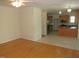 Open-concept living area with hardwood floors connecting the dining and kitchen areas at 1623 Rogers Pointe Ln, Creedmoor, NC 27522