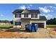 Two-story home featuring vinyl siding, black shutters, and an attached two-car garage at 163 N Movado Trl, Kenly, NC 27542