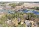 Stunning aerial view of home nestled in a lush landscape near a beautiful pond and open fields at 167 Coachmans Cove Rd, Four Oaks, NC 27524
