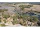 Expansive aerial view showcasing multiple properties near a tranquil lake, offering serene community living at 167 Coachmans Cove Rd, Four Oaks, NC 27524
