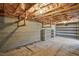 Unfinished basement with cinder block walls, exposed ceiling, and simple shelving offers potential for customization at 167 Coachmans Cove Rd, Four Oaks, NC 27524