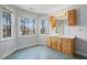 Well-lit bathroom with wood cabinets, large mirror, and multiple windows overlooking the trees at 167 Coachmans Cove Rd, Four Oaks, NC 27524