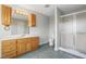 Bathroom features a wooden vanity with a shower featuring glass doors at 167 Coachmans Cove Rd, Four Oaks, NC 27524