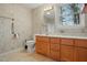Bathroom features a wooden vanity with storage, a mirror, and a single window at 167 Coachmans Cove Rd, Four Oaks, NC 27524