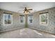 Bedroom featuring wallpaper has three windows that fill the space with natural light at 167 Coachmans Cove Rd, Four Oaks, NC 27524