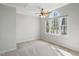Bright bedroom features a ceiling fan and natural light from the large windows at 167 Coachmans Cove Rd, Four Oaks, NC 27524