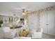A spacious bedroom features floral wallpaper, hardwood floors, and plentiful natural light through the windows at 167 Coachmans Cove Rd, Four Oaks, NC 27524