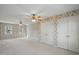 A spacious bedroom features floral wallpaper, hardwood floors, and plentiful natural light through the windows at 167 Coachmans Cove Rd, Four Oaks, NC 27524