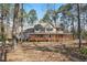 Charming two-story home featuring a welcoming front porch and surrounded by mature trees at 167 Coachmans Cove Rd, Four Oaks, NC 27524