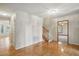 Inviting foyer with hardwood floors, a staircase, and access to other rooms in the home at 167 Coachmans Cove Rd, Four Oaks, NC 27524