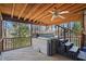 Covered screened porch area featuring a hot tub and steps for relaxation and enjoyment at 167 Coachmans Cove Rd, Four Oaks, NC 27524