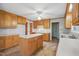 Traditional kitchen features wooden cabinets, a center island, and a ceiling fan at 167 Coachmans Cove Rd, Four Oaks, NC 27524