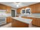 Traditional-style kitchen with light wood cabinets, white countertops and an island at 167 Coachmans Cove Rd, Four Oaks, NC 27524