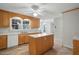 A kitchen featuring light wood cabinets and white countertops along with a central island at 167 Coachmans Cove Rd, Four Oaks, NC 27524