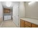 Bright laundry room with a pair of white appliances and a white folding counter at 167 Coachmans Cove Rd, Four Oaks, NC 27524
