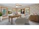 An office space offers a wooden desk and cabinet with several windows that offer natural lighting at 167 Coachmans Cove Rd, Four Oaks, NC 27524