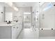 Modern bathroom with double sink vanity, a large glass shower, and marble tiling at 1801 Angelonia Way, Fuquay Varina, NC 27526