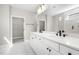 Elegant bathroom features a double vanity, matte black fixtures, and marble-look tile at 1801 Angelonia Way, Fuquay Varina, NC 27526