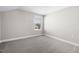 Cozy bedroom featuring a window with blinds and plush gray carpeting at 1801 Angelonia Way, Fuquay Varina, NC 27526