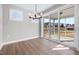 Dining room featuring hardwood floors, modern chandelier, and sliding glass doors to outdoor space at 1801 Angelonia Way, Fuquay Varina, NC 27526