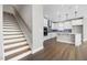 Modern kitchen with white cabinets, stainless steel appliances and access to the stairway in an open layout at 1801 Angelonia Way, Fuquay Varina, NC 27526