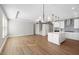 Open-concept living area featuring hardwood floors, recessed lighting, and a kitchen with a center island at 1801 Angelonia Way, Fuquay Varina, NC 27526